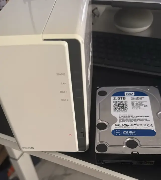 Network storage enclosure beside a 2TB WD Blue hard drive