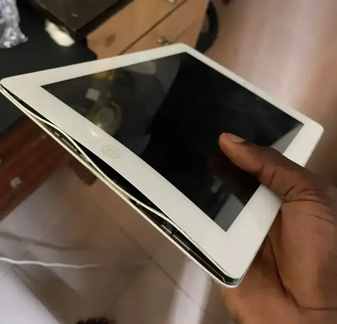 White iPad with its screen lifting away from the frame