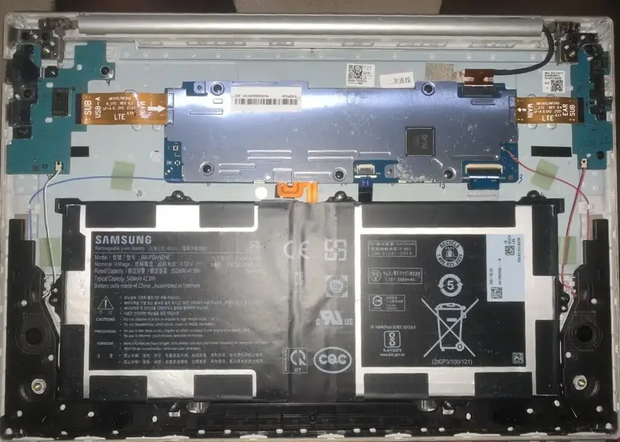 Samsung laptop opened up showing its battery and motherboard